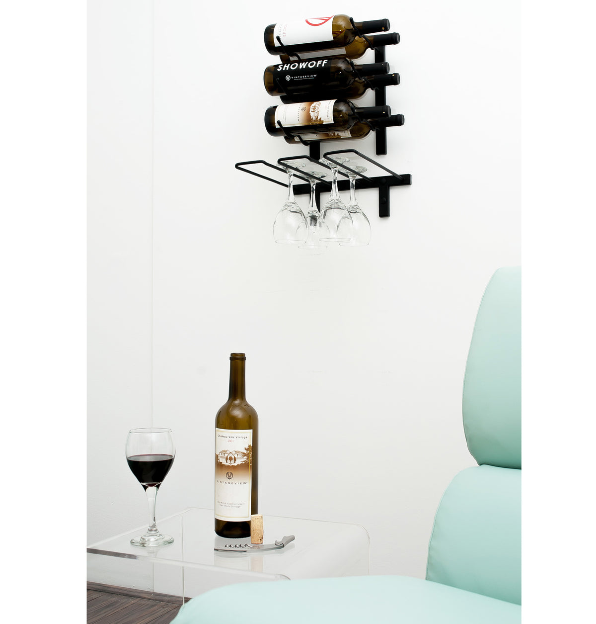Black wall-mounted stemware rack with a few hanging wine glasses
