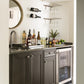 Wall-mounted stemware rack above a countertop with hanging wine glasses