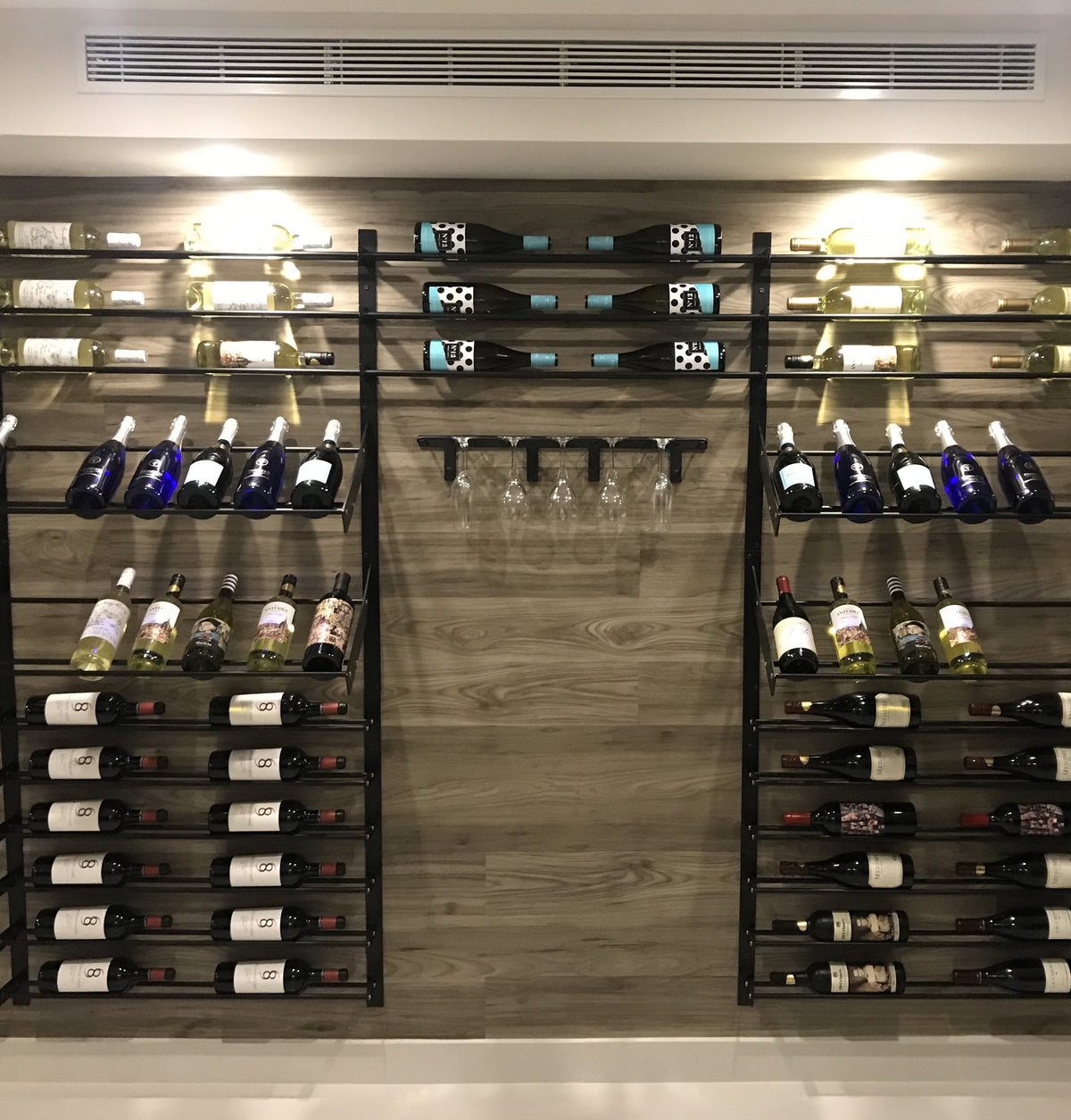 Wall-mounted wine and stemware rack with glass cups hanging below