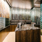 Wall-mounted stemware rack with hanging glassware near a bar counter