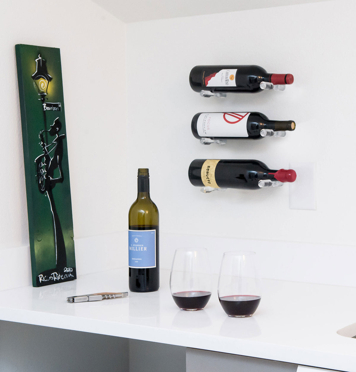Wall-mounted wine bottle pins holding three bottles with metal fasteners