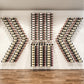 Wine bottle pin rack system with black holders, bottles displayed in wall rows