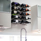 Wall-mounted wine bottle holder with curved metal pins beneath a cabinet rack