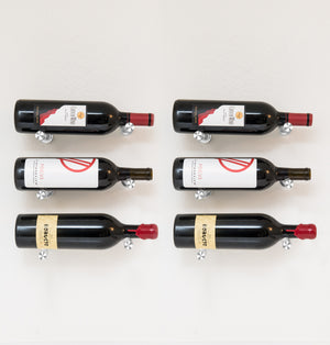 Set of 6 black wine bottle pin holders with angled red caps and metal display pins