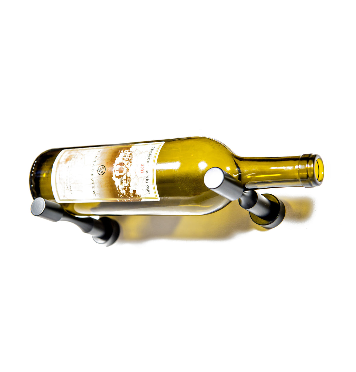 Wine bottle holder pins with black prongs on a golden glass wine bottle
