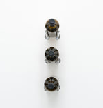 Wall-mounted 3-bottle rail with three clear bottle-holder caps and a dark metal base
