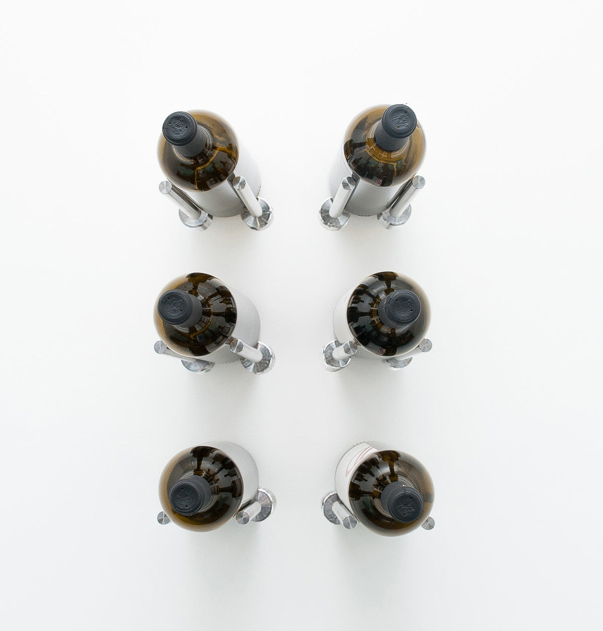 Wine rail designer grid with six bottle holders, silver metal caps on amber bottles