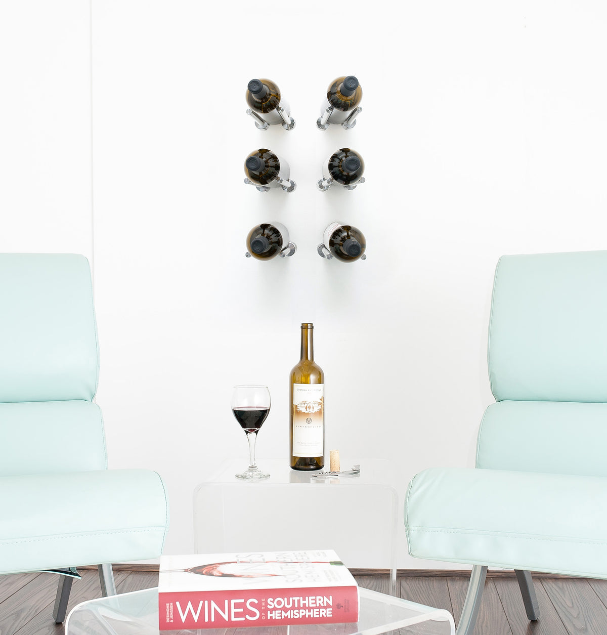 Wine bottle rail designer grid with six holders on a wall above a table setting