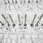 Set of stemware goblets on two-bar stemware rack with polished metal holders