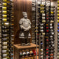 Floating wall frame with wine bottle display racks and a carved stone figure statue