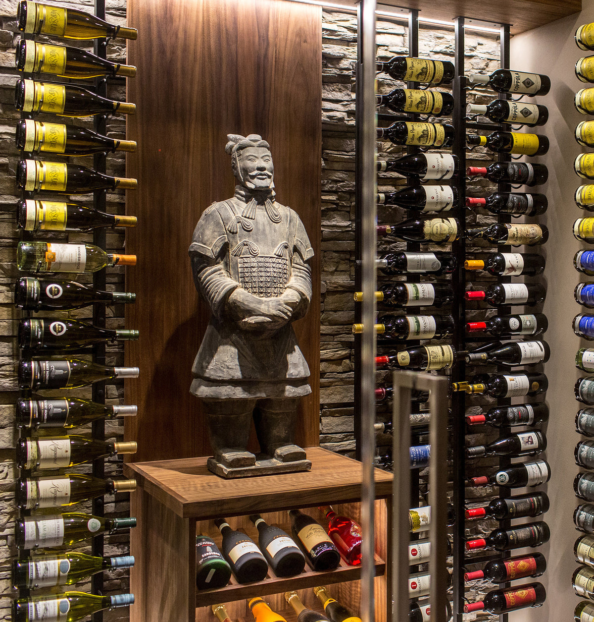 Floating wall frame with wine bottle display racks and a carved stone figure statue