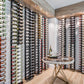 Large wall wine rack display with black frame and many wine bottles