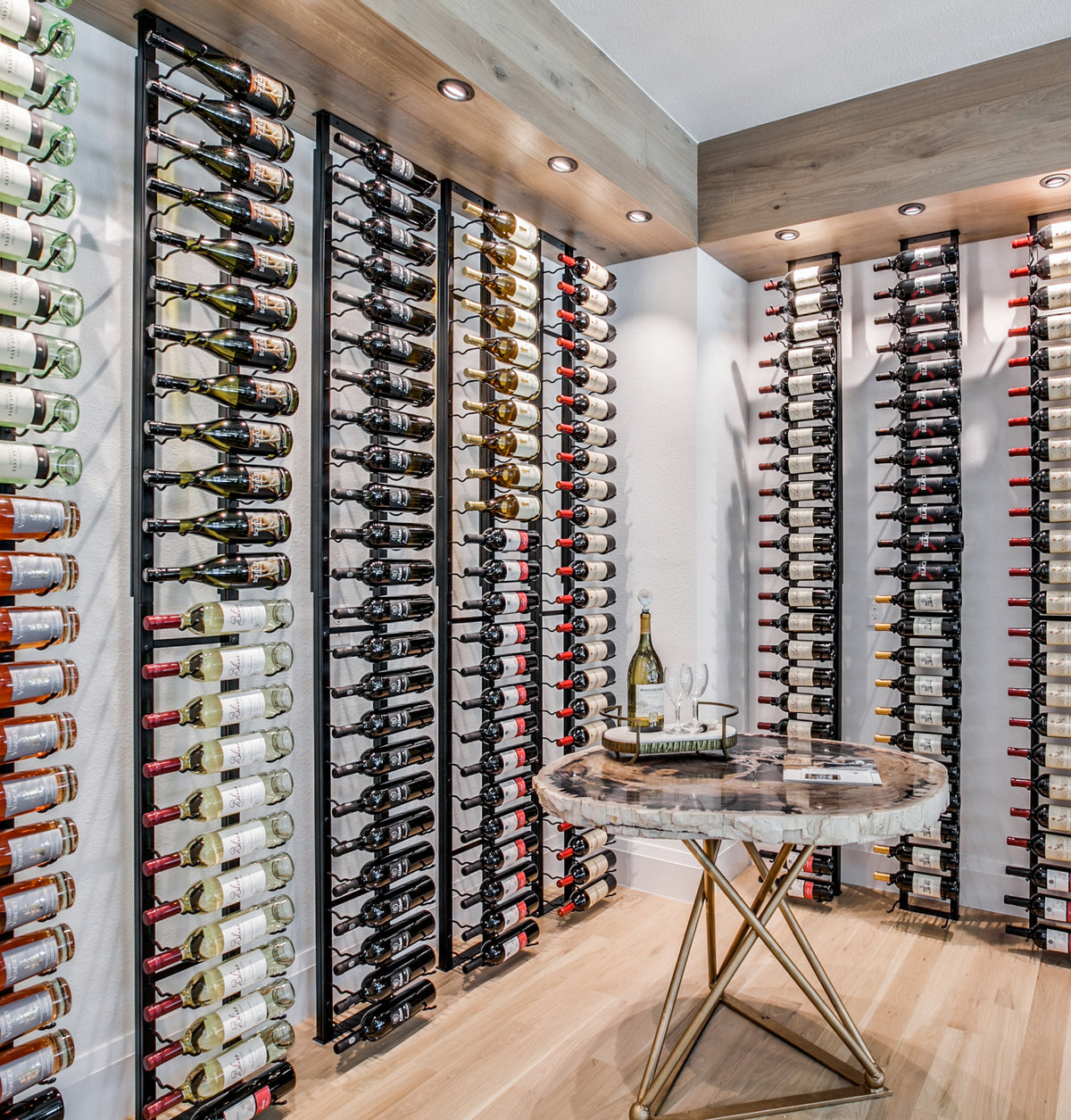Large wall wine rack display with black frame and many wine bottles