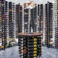 Wine storage wall with metal bottle rails and floating frame section