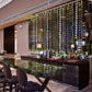 Wall-mounted wine bottle display with illuminated rails and floating frame design
