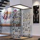 Freestanding glass wine tower with multiple levels of bottle storage and metal rails