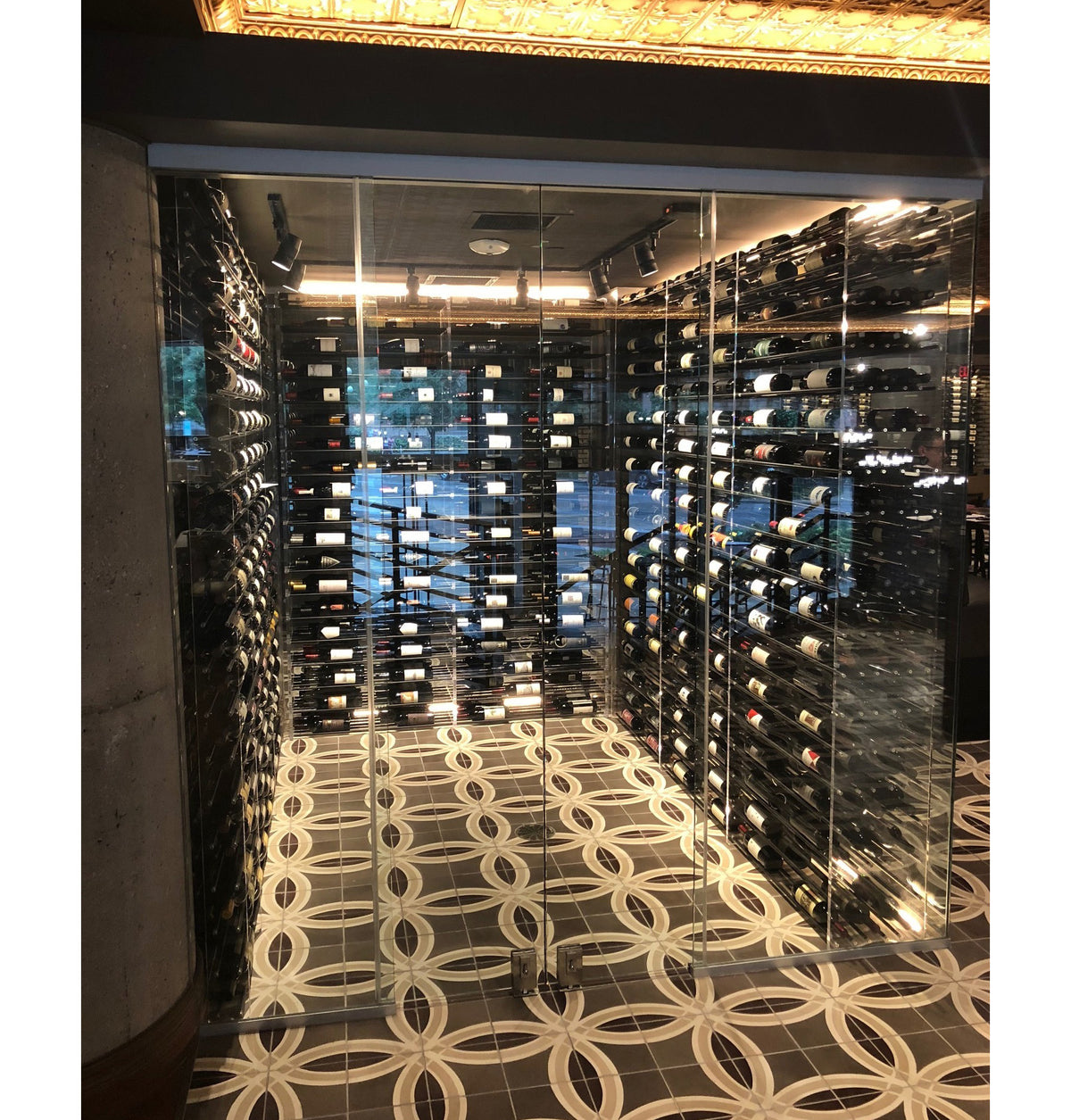 Built-in glass wine tower with internal racks and evenly spaced bottle storage