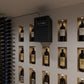 Through-wall cooling unit centered above a wall of wine bottles