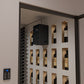 Wine bottle wall with through-wall cooling unit and remote thermostat panel