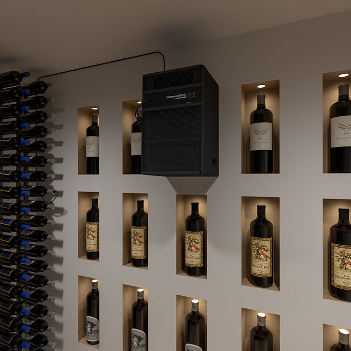Through-wall wine cooling system installed above a wine bottle display wall