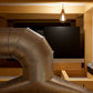 Silver ductwork with elbow bends for wine cellar cooling system installation