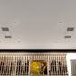 Ceiling-mounted ductless cooling vents with airflow indicators above the unit