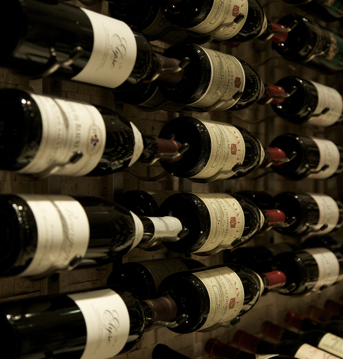 Close-up of wine bottles in a wall-mounted wine rack