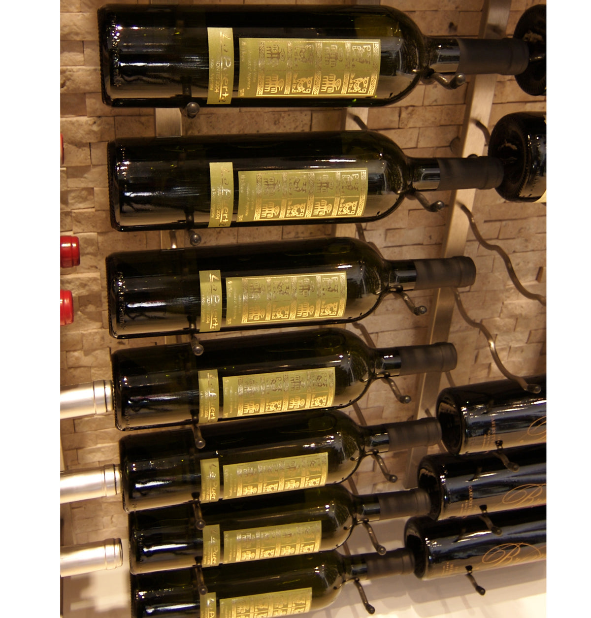 Wall-mounted wine rack with dark wine bottles on curved black metal arms