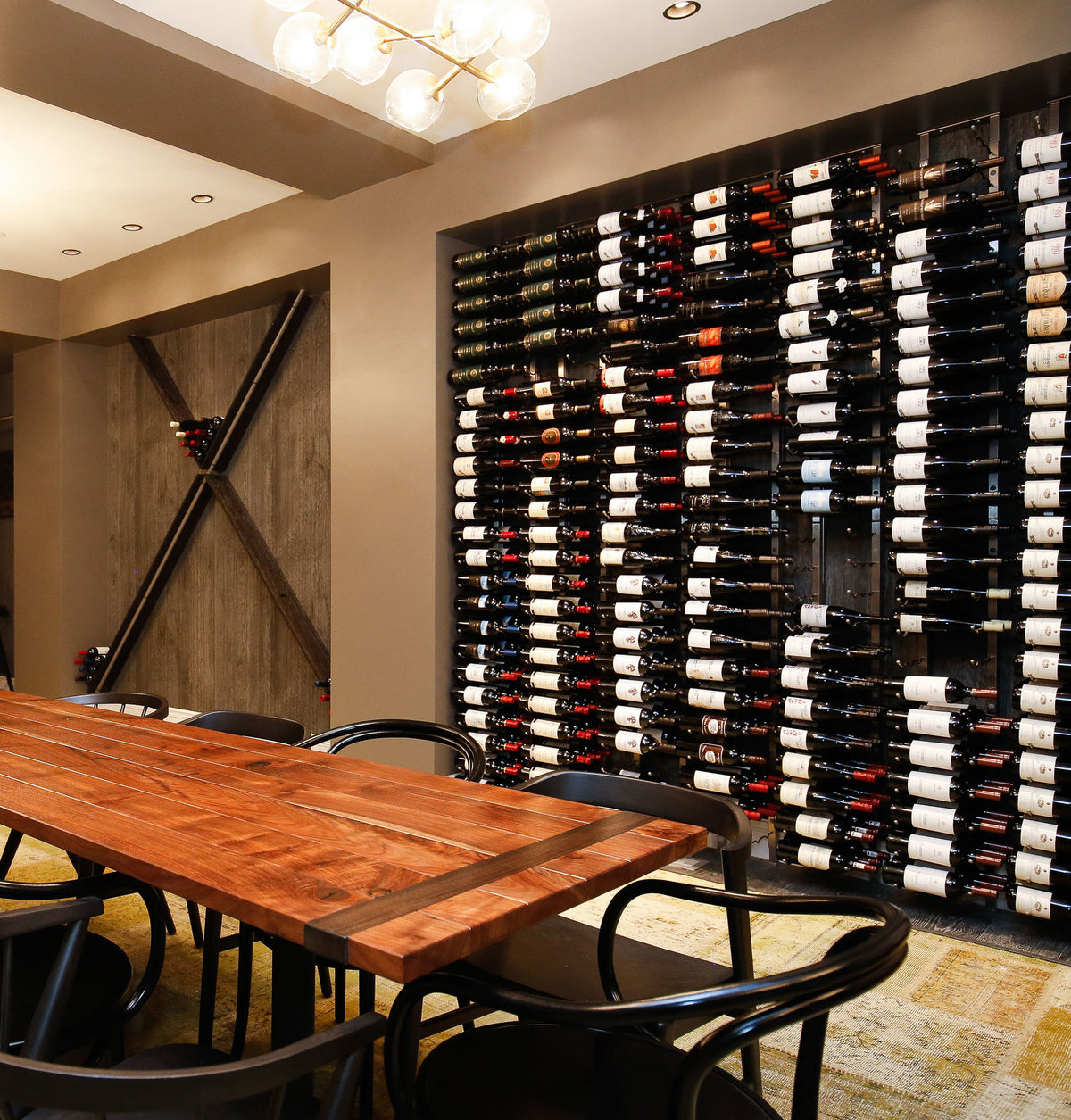 Wall wine rack with black frame holding rows of wine bottles indoors