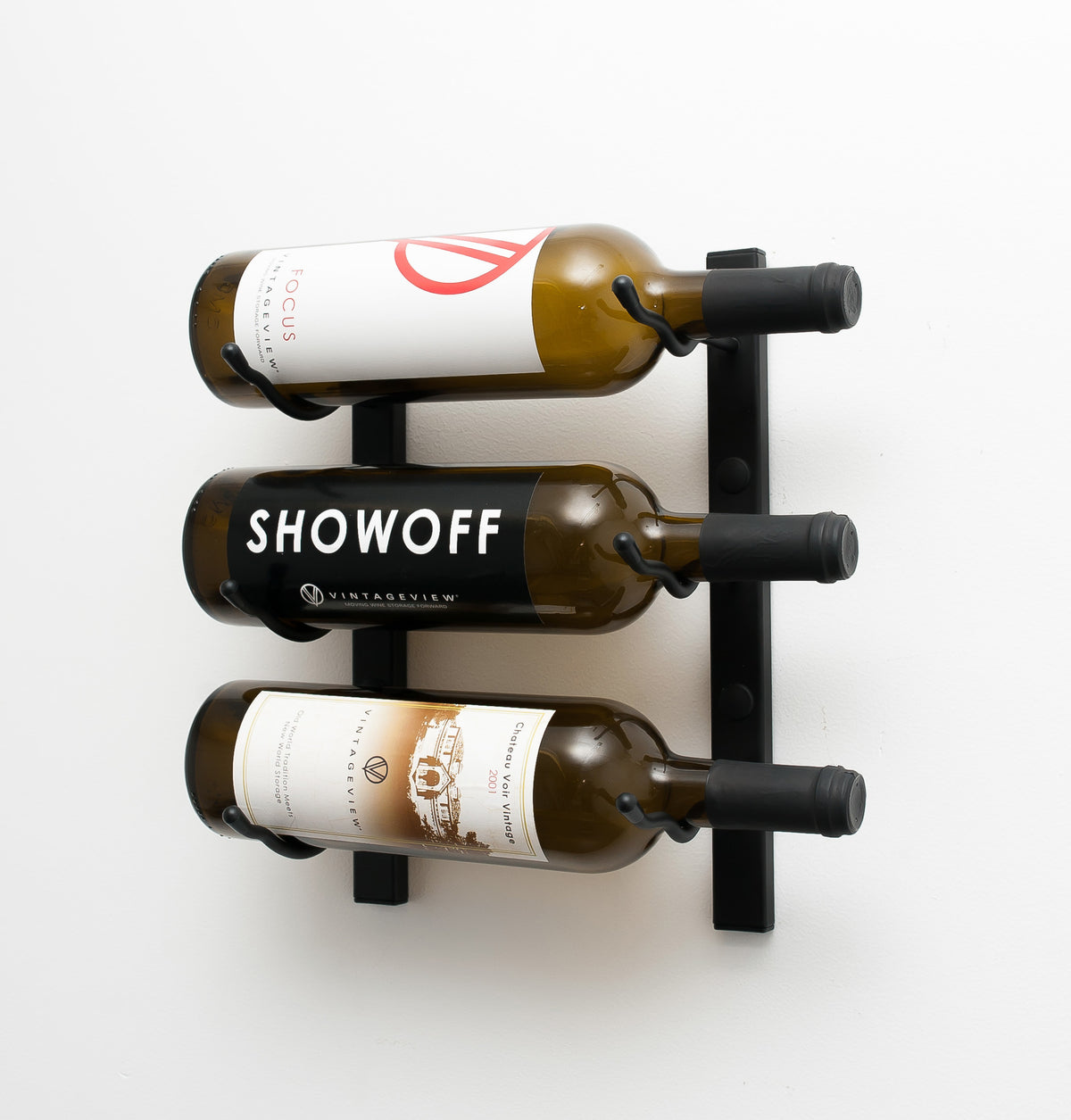 Wall-mounted wine rack with three wine bottles in black metal holders