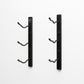 Wall-mounted wine rack bracket set in matte black with curved bottle hooks
