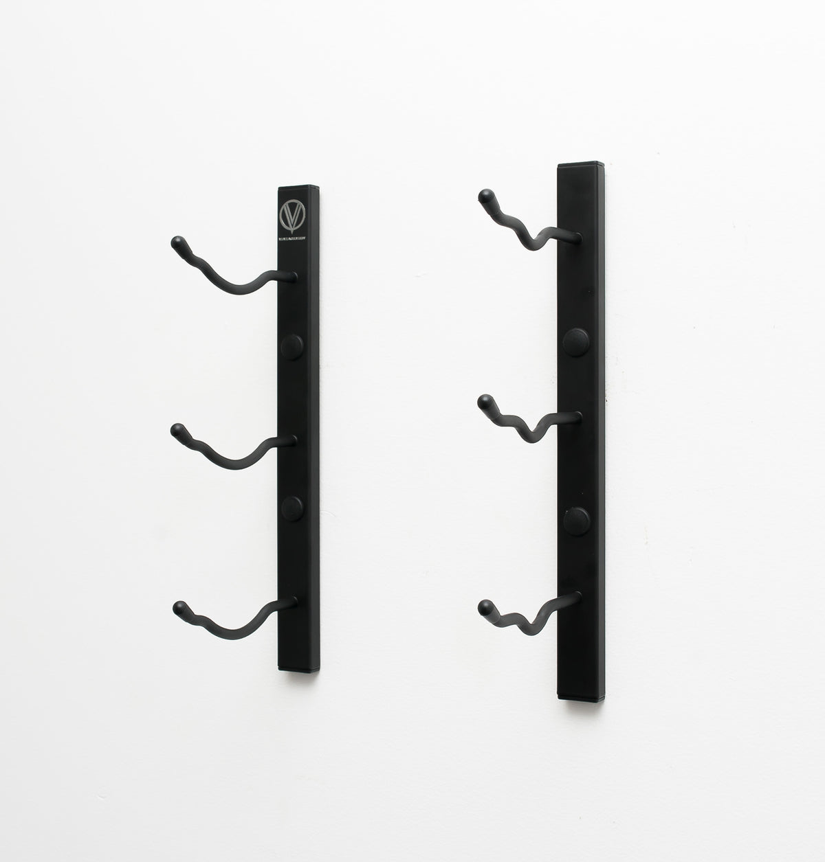 Wall-mounted wine rack bracket set in matte black with curved bottle hooks
