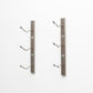 Wall-mount wine rack with three curved bottle pegs on brushed metal bars