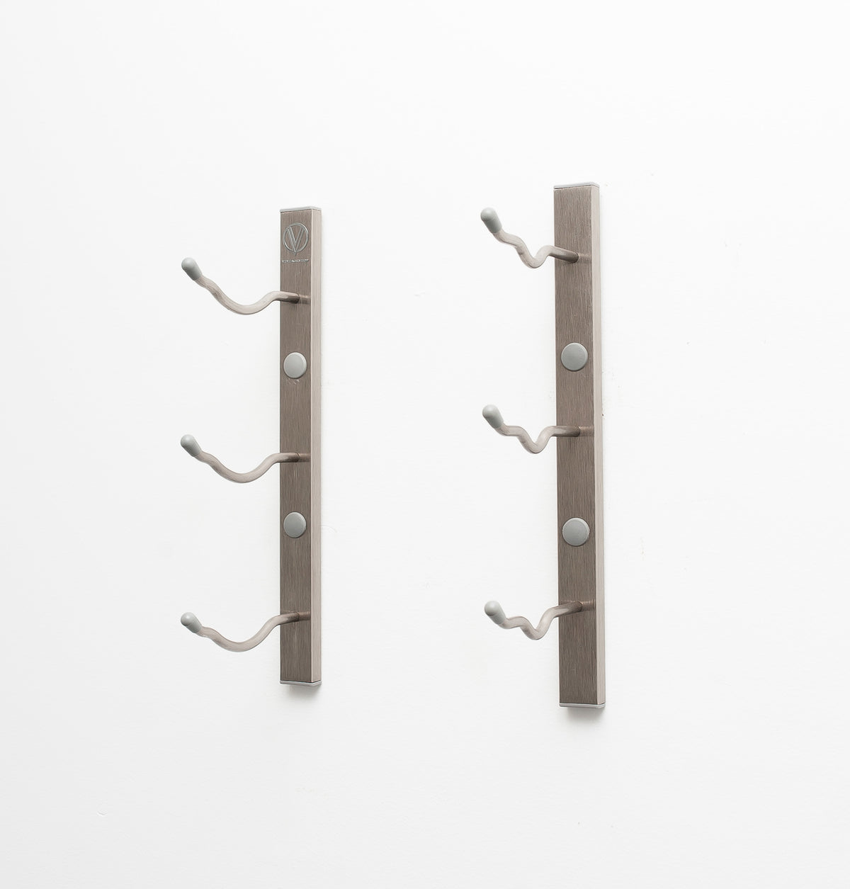 Wall-mount wine rack with three curved bottle pegs on brushed metal bars