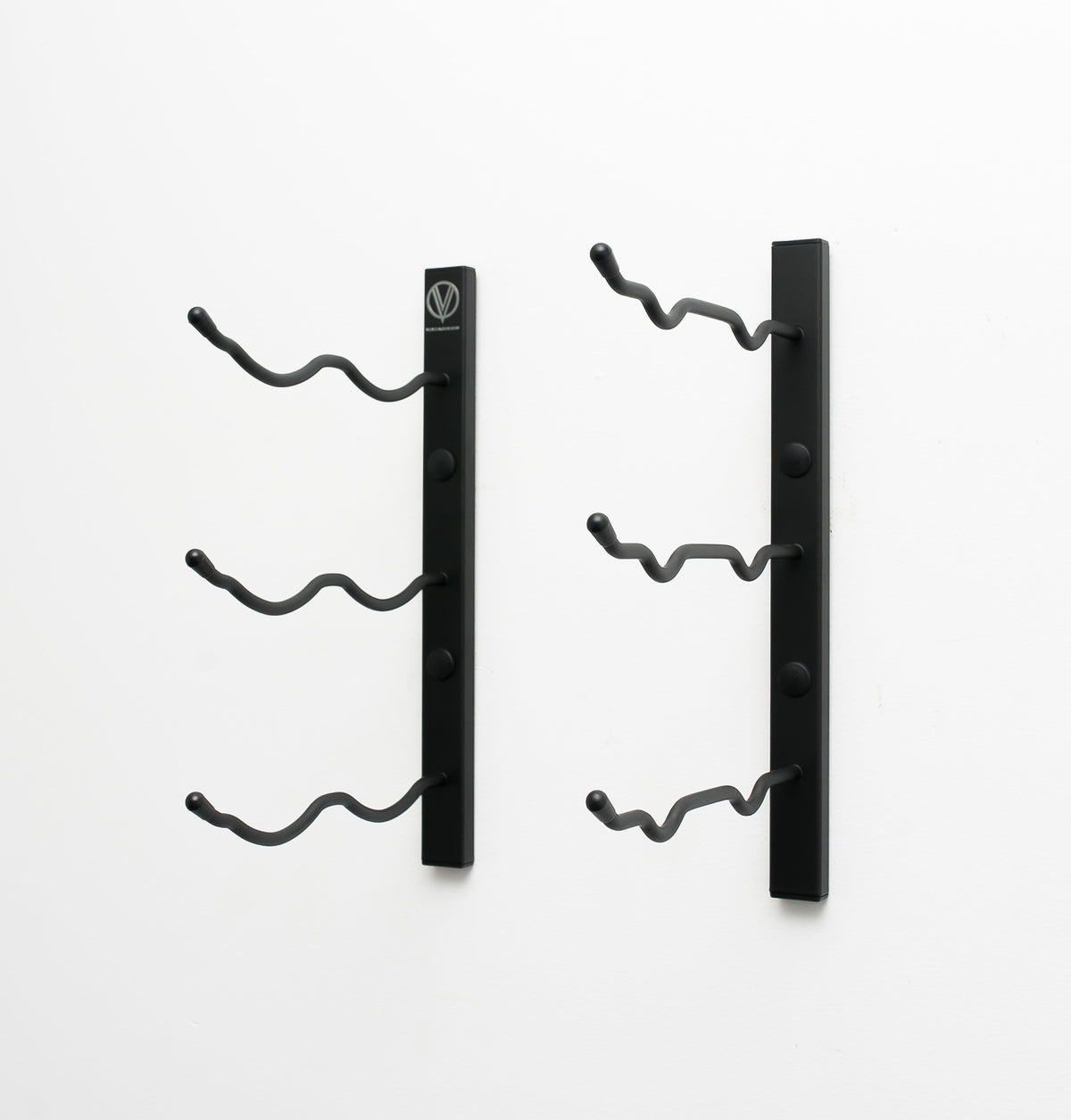 Wall-mount wine rack with two black vertical bars and six curved bottle pegs