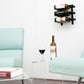 Wall wine rack with three bottle slots mounted above a glass and wine bottle