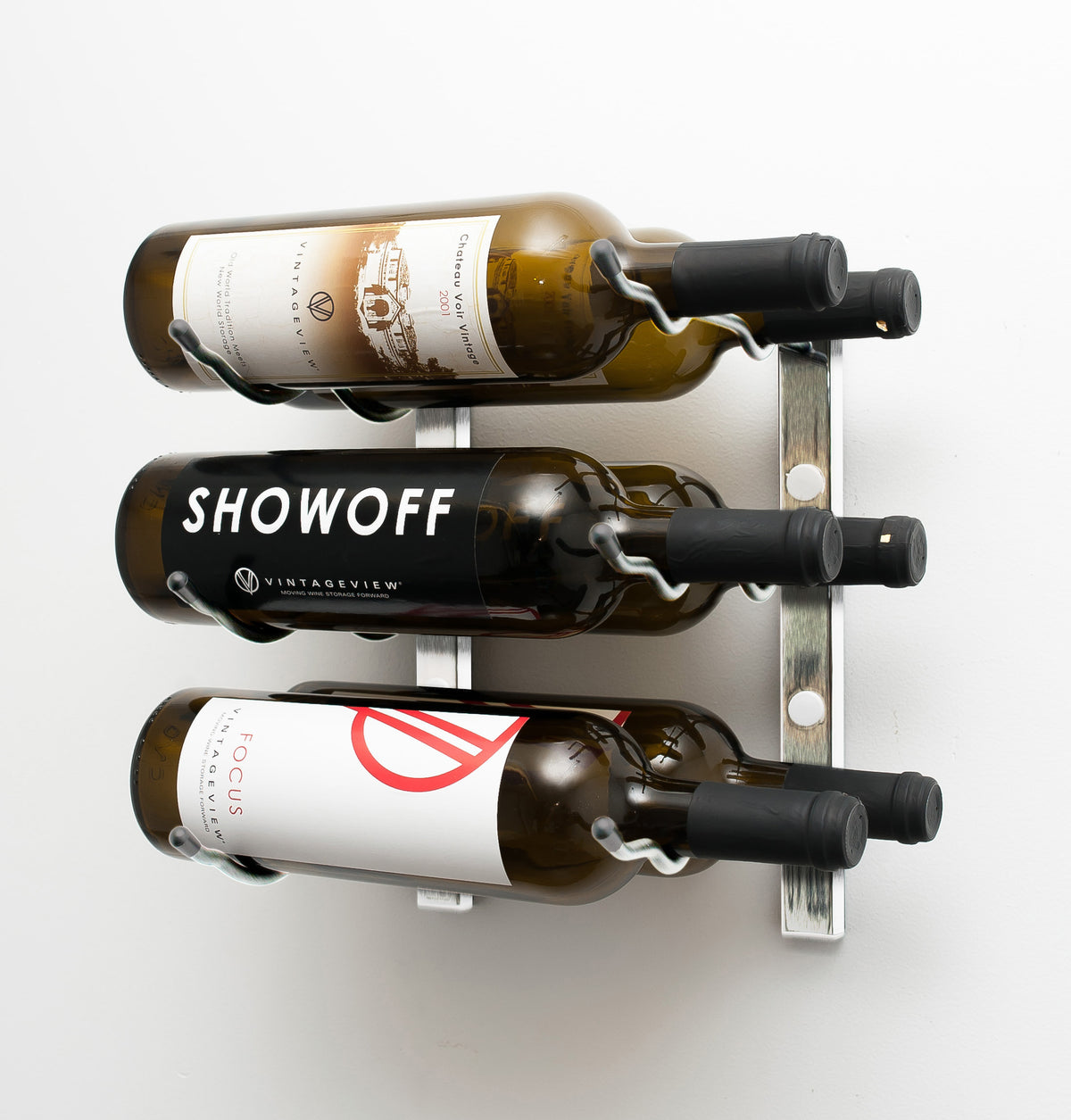 Wall-mounted wine rack with dark frame and metal bracket holding three wine bottles