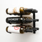 Wall-mounted wine rack with three bottle slots and assorted wine bottles on display