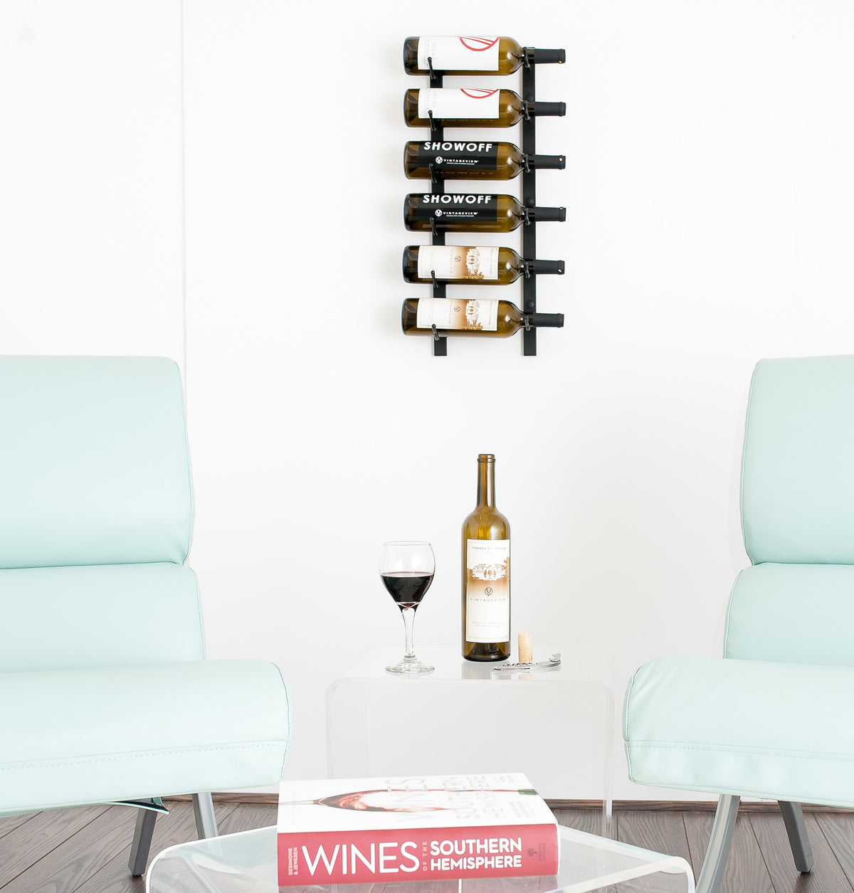 Wall-mounted matte black wine rack with bottle hooks holding wine bottles
