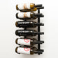 Wall wine rack with silver back and black pegs holding six labeled wine bottles