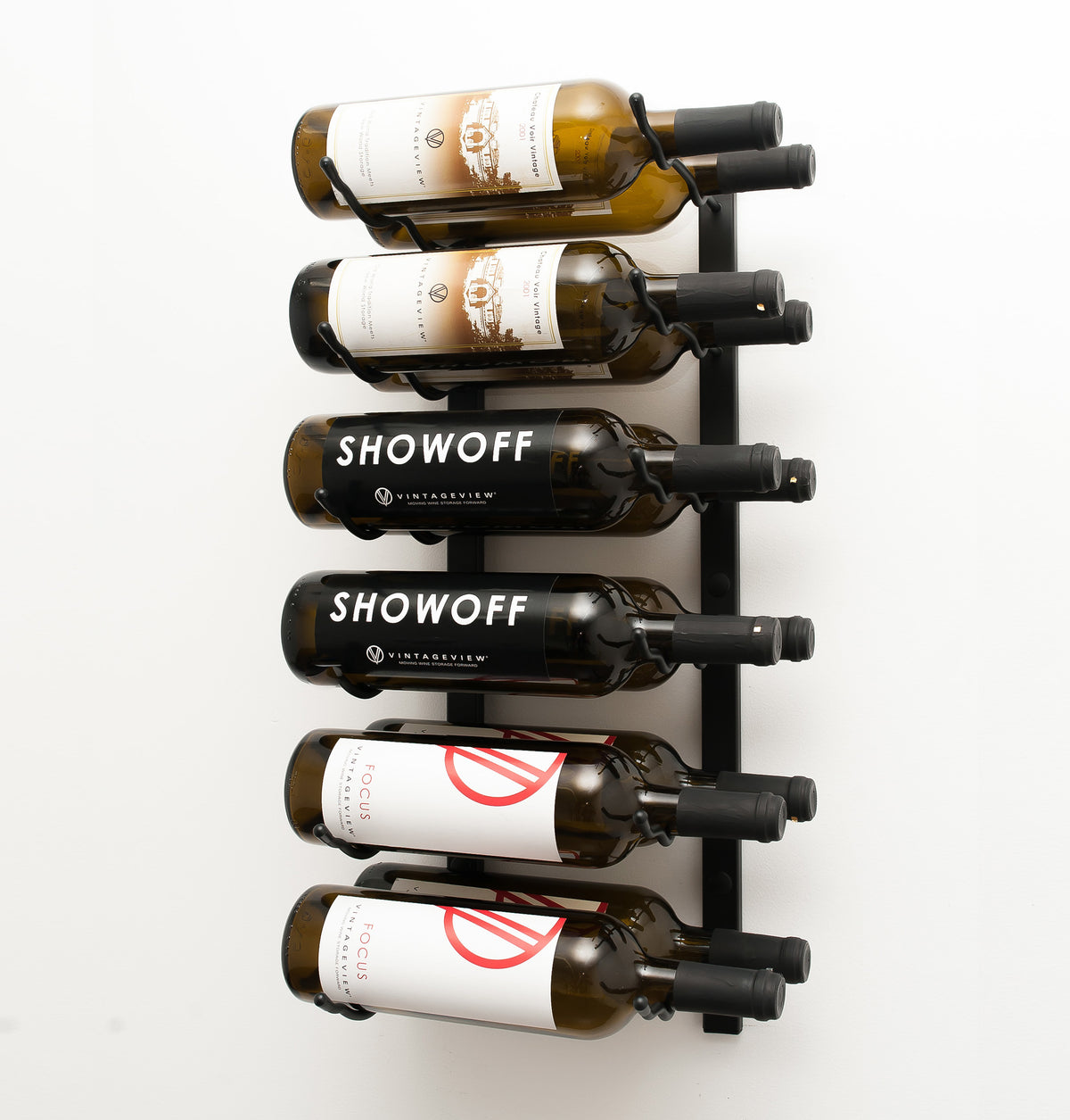 Wall wine rack with silver back and black pegs holding six labeled wine bottles