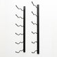 Wall-mounted wine rack with empty curved bottle holders on two black metal bars