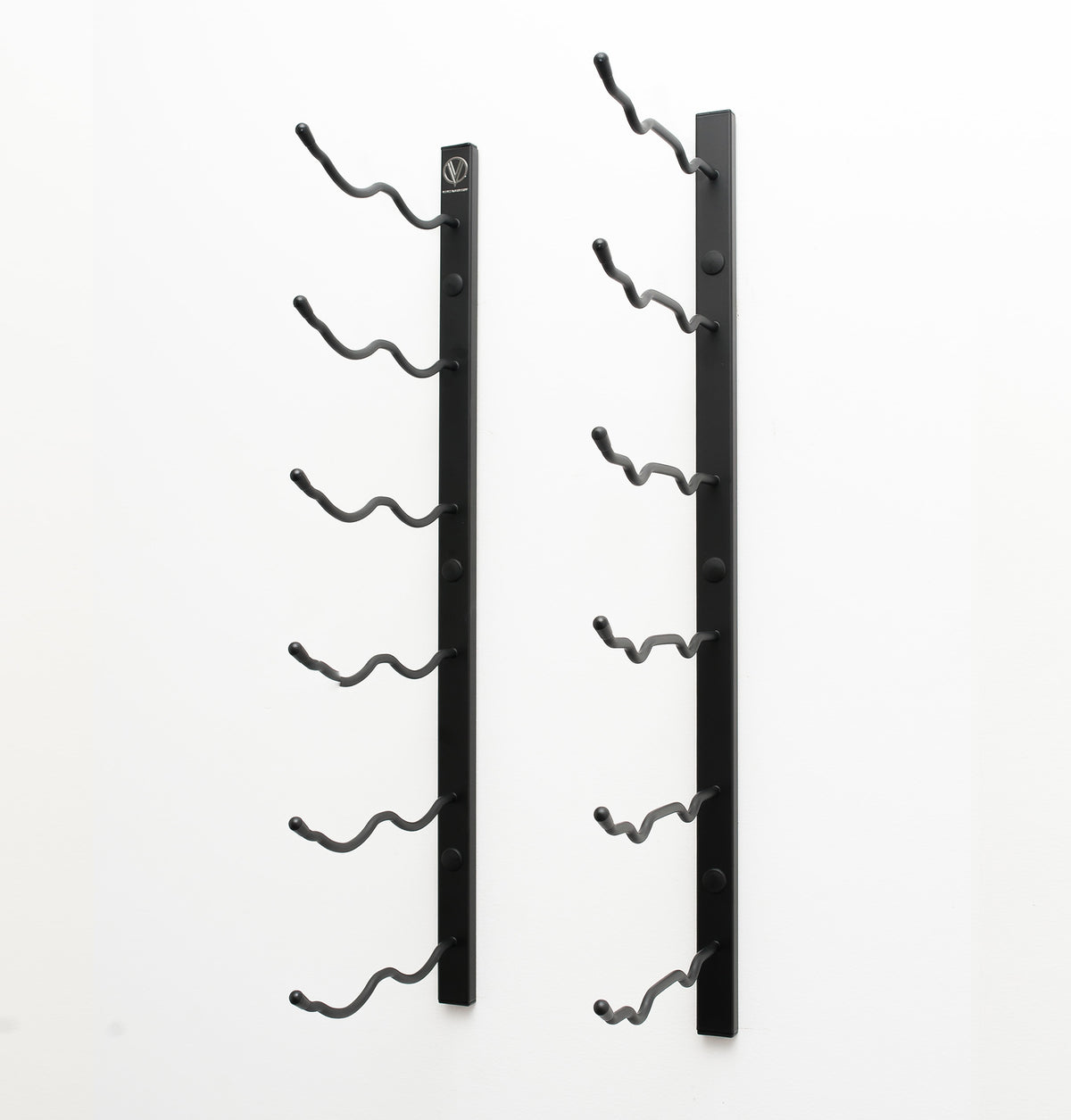 Wall-mounted wine rack with empty curved bottle holders on two black metal bars