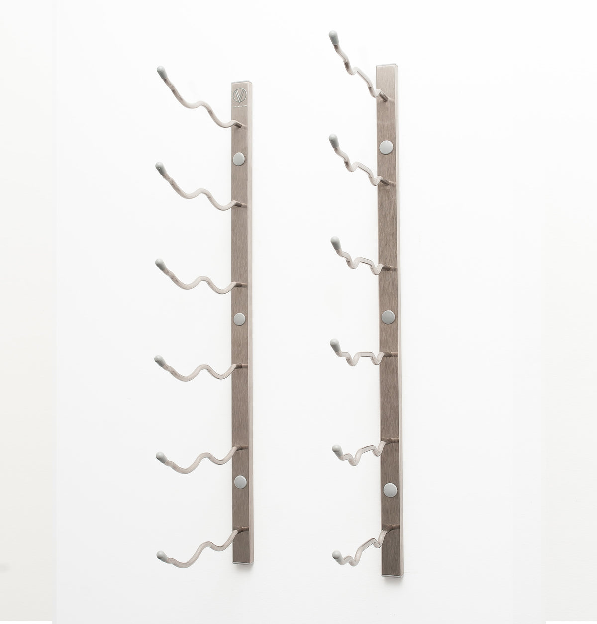 Wall-mounted wine rack with empty curved bottle holders on bronze-colored metal bars