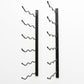 Wall-mounted wine rack with empty curved bottle holders on matte black metal bars