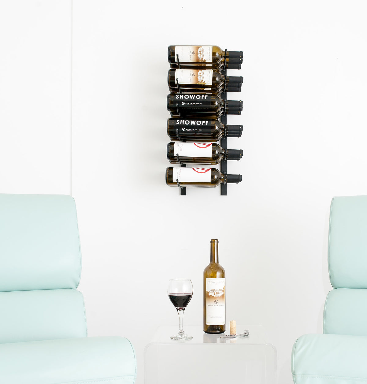 Wall wine rack with bottle holders and two wine bottles in the top row
