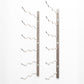 Wall wine rack with empty curved bottle holders on a light gray metal bar