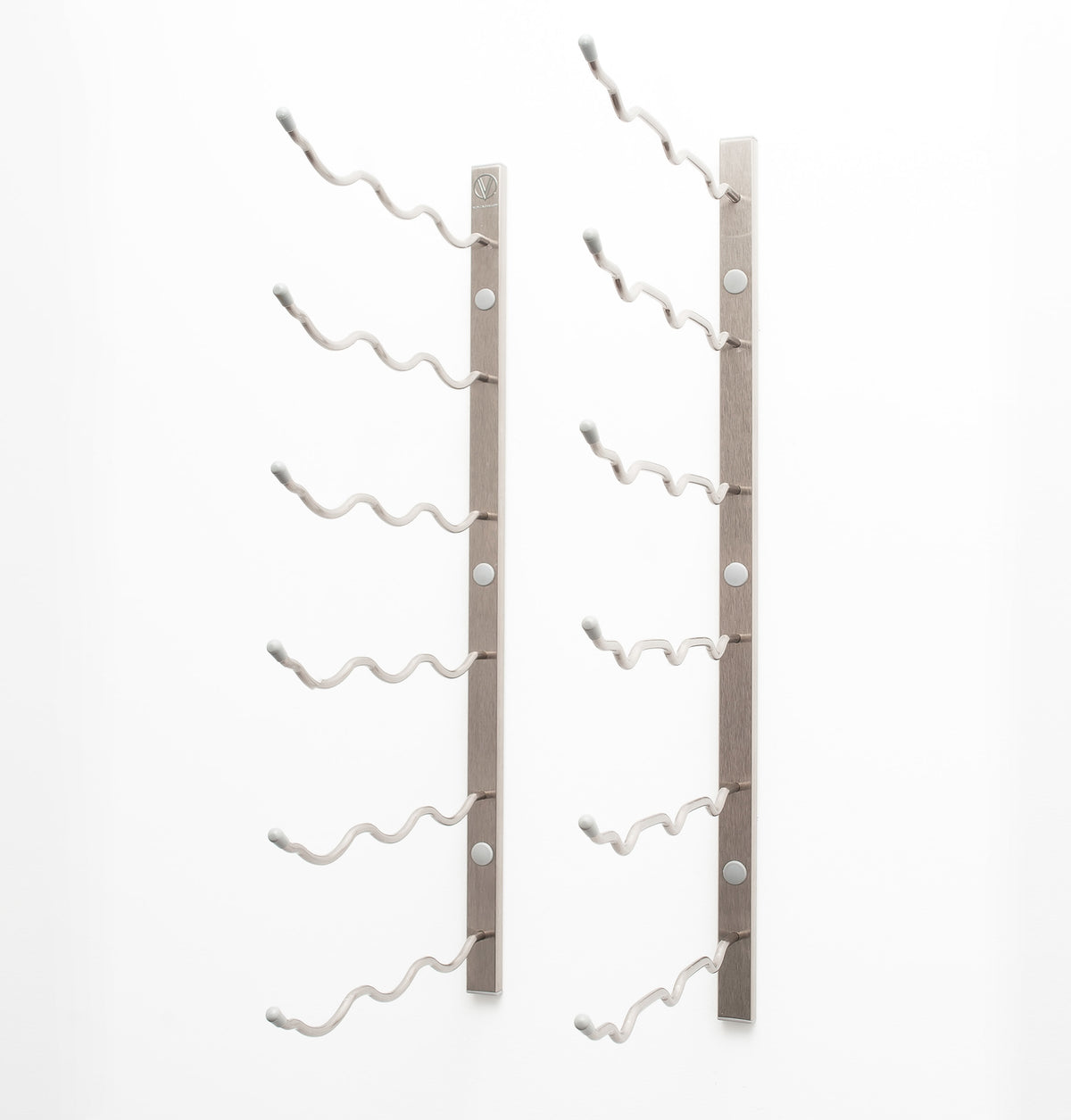 Wall wine rack with empty curved bottle holders on a light gray metal bar