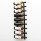 Wall-mounted wine rack holding wine bottles on black vertical bars