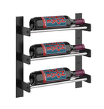Black wall wine rack with three wine bottles on light wood-toned shelves